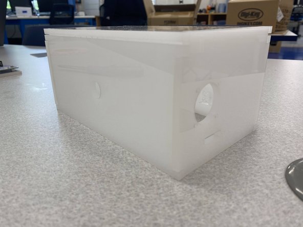 Add three more strips of VHB tape to the other side of the spacer to attach this assembly to the enclosure.