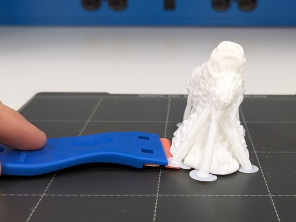 Once you've removed the print surface you can flex it (don't be afraid to apply a good deal of pressure/flex) to detach your print from the surface.