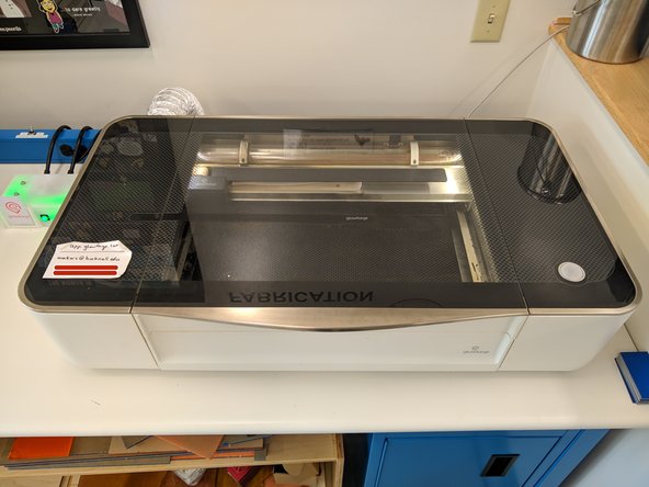 The Glowforge will power on and spend several minutes aligning the laser head and calibrating the camera.  Do not open the lid during this process.