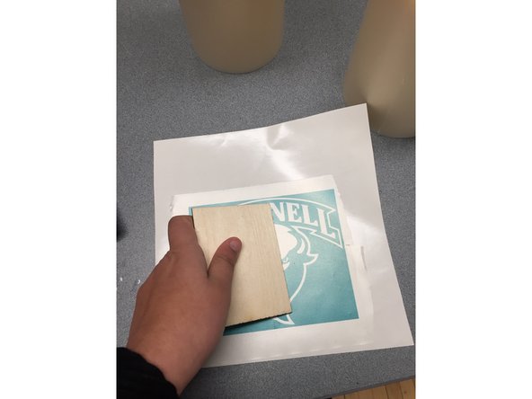 Cut down the roll of clear transfer tape to a size that would be manageable and similar to the size of the sticker/decal you just cut.