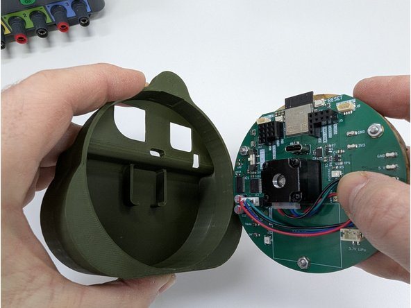 Locate the 3D printed shell back.  Orient the shell back such that the opening is pointing up and the flat edge faces towards you.  See the first image.