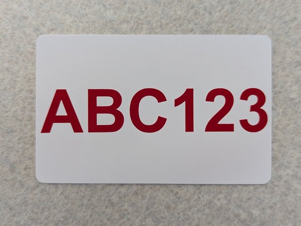 Again use the white squeegee to apply uniform pressure across the transfer tape and card to ensure that the vinyl decal adheres to the card.