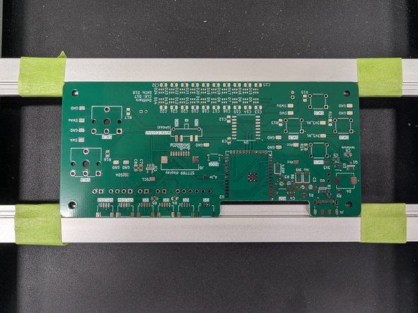 There are green pieces of tape to show you where to position your PCB.  Please position it with the cutout facing down or towards you as shown in the second photo here.