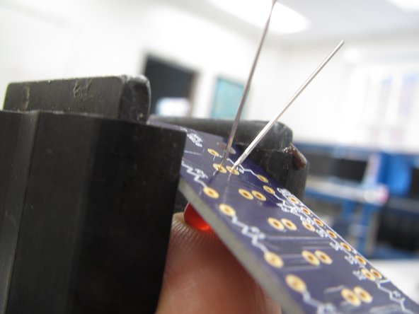 It is best to clamp the PCB in a vice to provide a sturdy base against which you can apply adequate pressure while soldering.