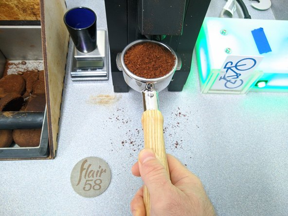 Hold the portafilter against the button to continue grinding until all of the beans have been ground.  Keep grinding until no more grinding sounds can be heard.  This ensures that no stale beans are left behind.