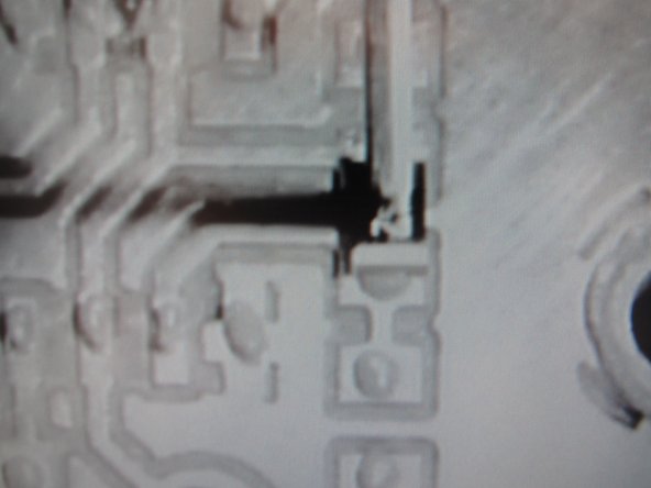 Slowly pull down on the knob to better align the component.  When you are confident the component is properly aligned, pull the knob down all the way to place the component on the pad containing solder paste.  Apply enough downward pressure to disengage the vacuum (green light should go out and hissing should stop).