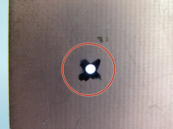 This piece of copper clad will accept a drill hole and then allow the camera to find and calibrate relative to this hole.