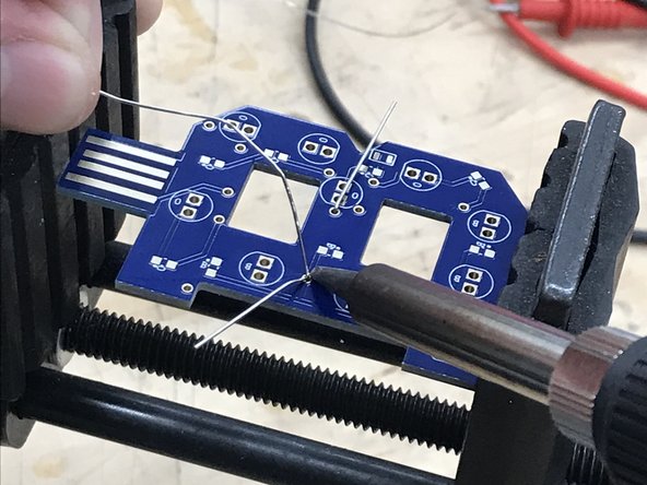 Now press the edge of the iron tip to both the component lead and the copper pad surrounding it.  The point is to heat up both surfaces which will be joined by solder.  If one or both are too cool the solder will not flow properly.