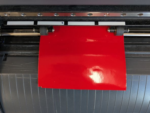 Once your vinyl is positioned properly, slide the black pinch rollers between the white alignment marks.