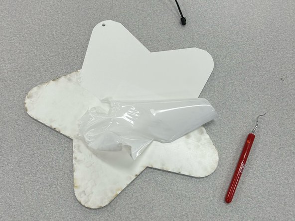 Peel the paper off of the acrylic.