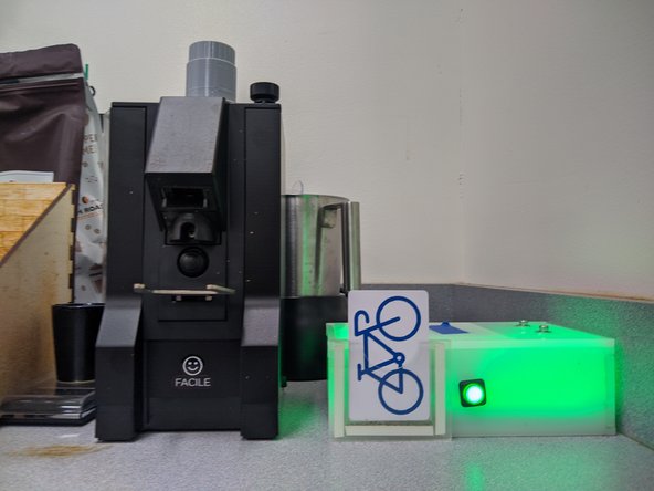 Place your makerspace card in the Portal box to power the grinder.  The box will glow green if a) you are authorized, and b) you have a positive account balance.  Your account will be debited for one cup of coffee.