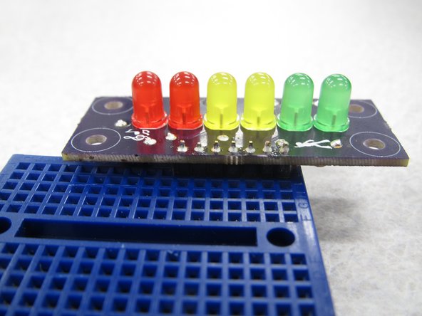 (25) With your header pins securely inserted in the breadboard place your PCB on top of the pins.