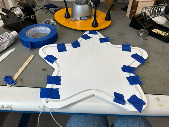 Any extra wire can be taped to the back of the sign