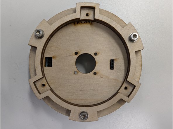 Insert the three bolts + washers through the three large holes.