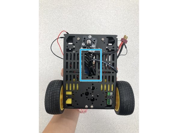 Now take the excess barrel plug wire and tuck it into the robot underneath to keep from tangling.