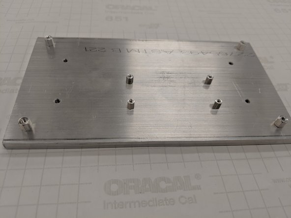 Screw the M2.5 standoffs into the four rectangular pattern holes offset from the center of the baseplate as shown in the last figure. These will be used to support the RPi.