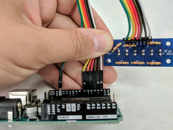 (27) Remove the Arduino from the plastic sled.  Locate the 7-wire ribbon cable in your bag.   Your ribbon cable colors may not match those shown here.