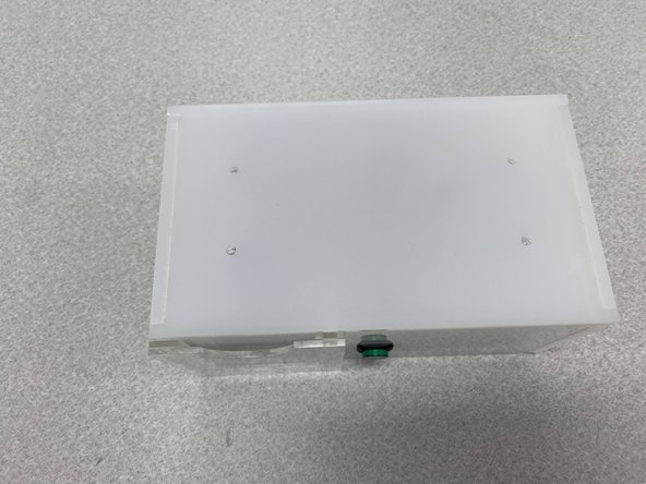 Place a washer on top of each of the four holes on top of the enclosure as shown in the second figure.