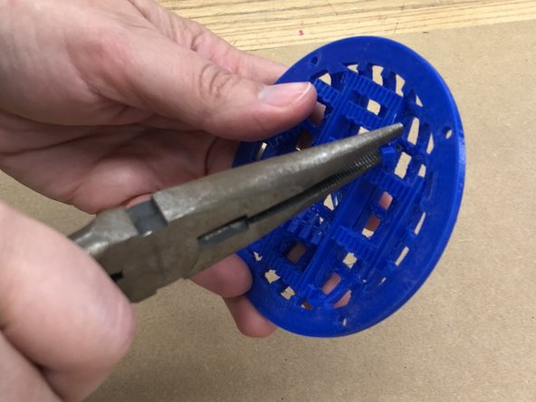 Using needle-nose pliers (or your hands, but we recommend the pliers), break off the support material from the underside of the domed speaker grilles.