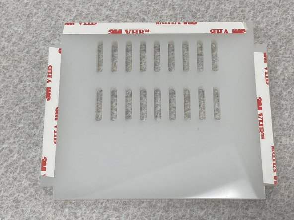 After cutting all the acrylic parts on the laser cutter then removing the paper backing, apply the 3M VHB tape on three sides of one of the side plates as shown in the first figure.