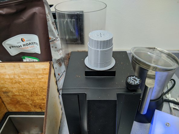 You need to remove stale grounds from building up in the grinder.  Remove the black plastic funnel and place the gray topper in the gray chute.