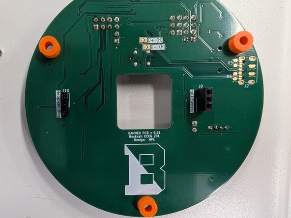 Locate the three plastic spacers in your parts kit.  Place one spacer on each of the three large holes around the edge of your PCB on the back side.