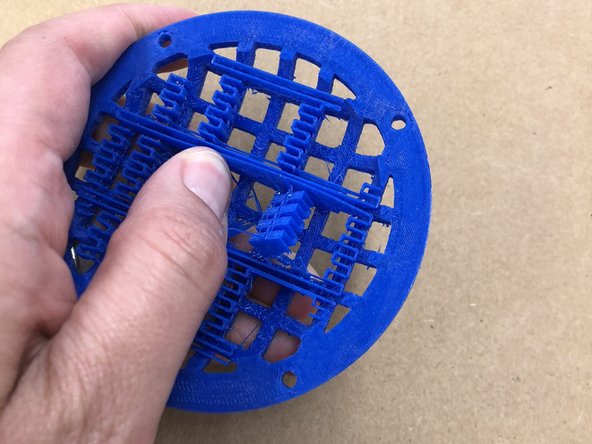 Remove the support material from the speaker grilles.