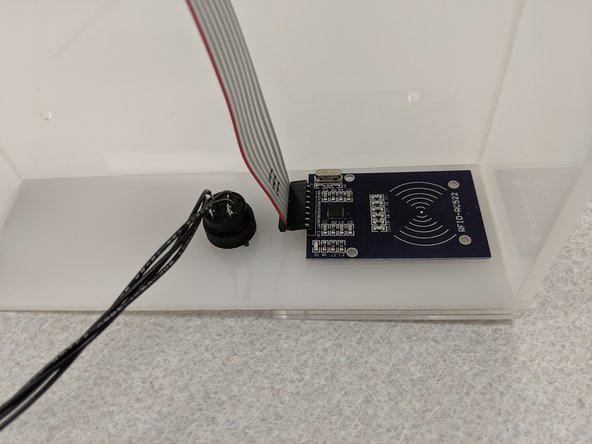 Secure the pushbutton in place by screwing the plastic nut back on and tightening it.