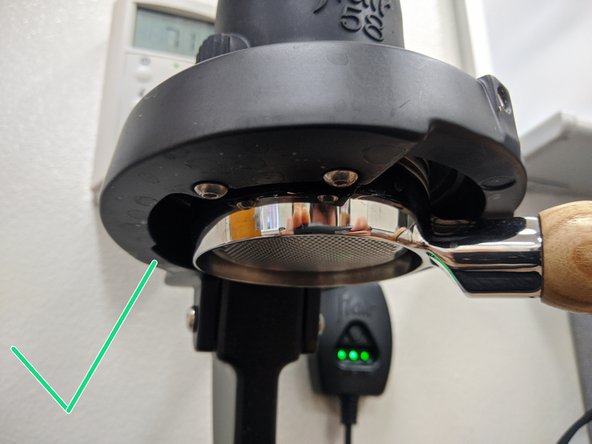 Insert the portafilter back into the Flair press at 6 o'clock.  Rotate it to the right to 4 o'clock.