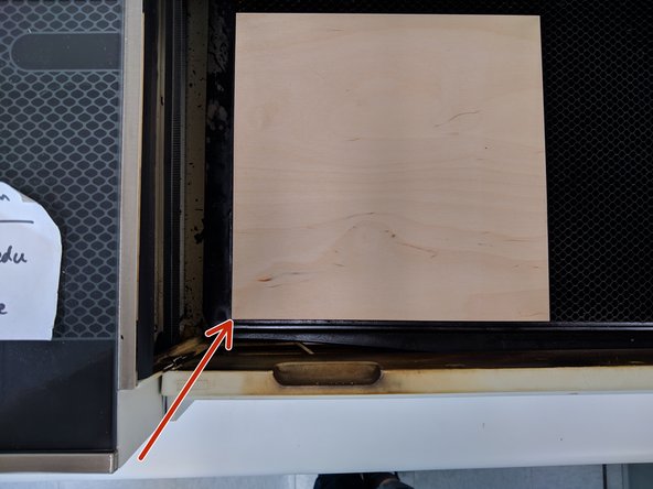 With your material properly covered, lift the Glowforge lid and place your material on the bed.