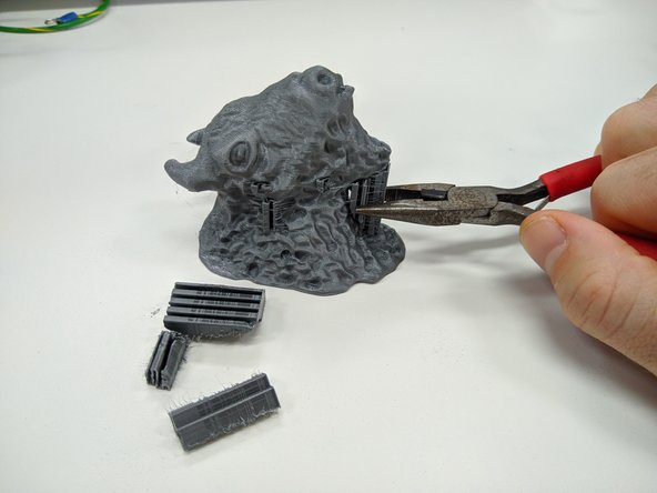 If your part had support material, you may now safely remove it.  Use pliers and exercise caution.