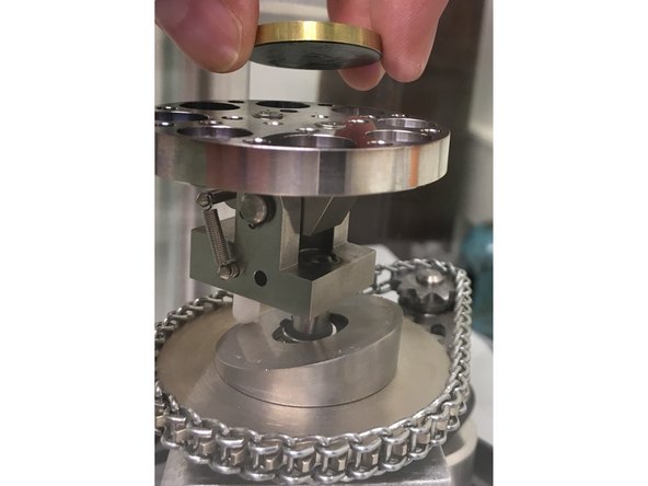 Adhere your specimen, mounted on a brass disk  to the stage using a carbon tape dot.