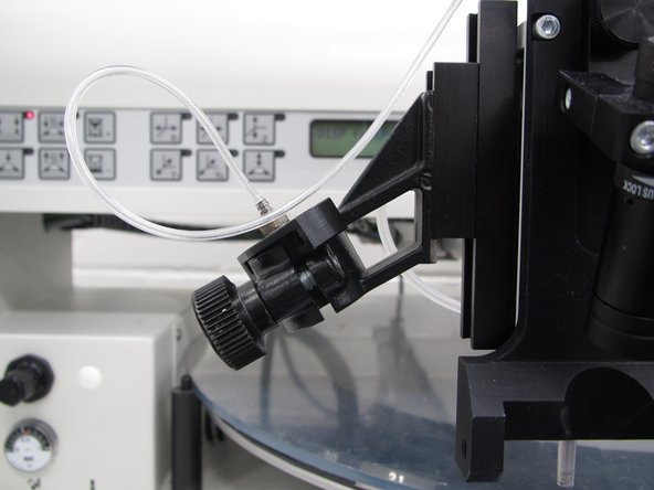 When you are done dispensing paste, use the placement knob to move the nozzle away from your PCB.  Pull the paste tube out of the holder.  Rotate the tube connector  90° so that the collars are perpendicular to the tube wings.  Rock the tube connector back and forth as you pull upwards in order to remove the connector from the tube.