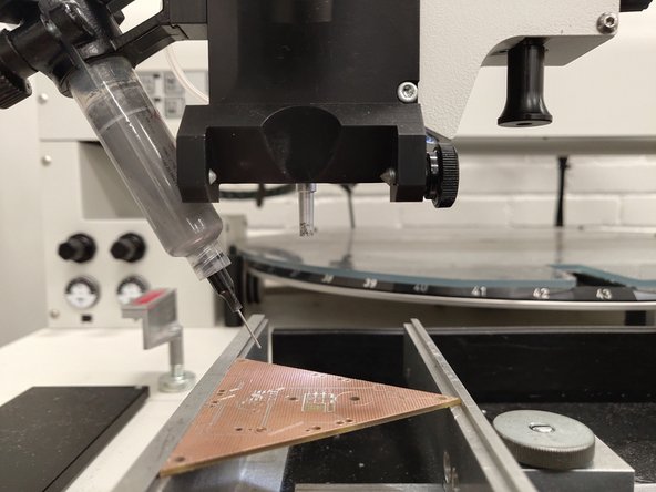 Insert the solder paste tube into the tube holder on the left of the placement head.  You should move the arm of the pick and place out towards you, and away from the parts carousel.  This will prevent the solder paste tip from hitting the carousel.
