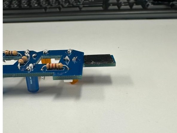 Use a small dab of super glue to hold the tab in place.  The glue should set within five minutes.  This tab will help ensure the PCB makes good contact inside of a USB port.