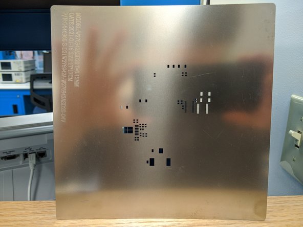 Be sure to clean all of the paste off the stencil using the IPA and a paper towel.  You will need to repeat this process multiple times, and alternate between sides as paste is pushed through the tiny holes.  Hold the stencil up to a light to verify no paste remains in the stencil holes.