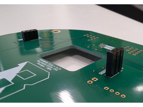 Similar to the previous step, place the socket on the bottom side of the PCB.  Hold it in place with some blue tape.