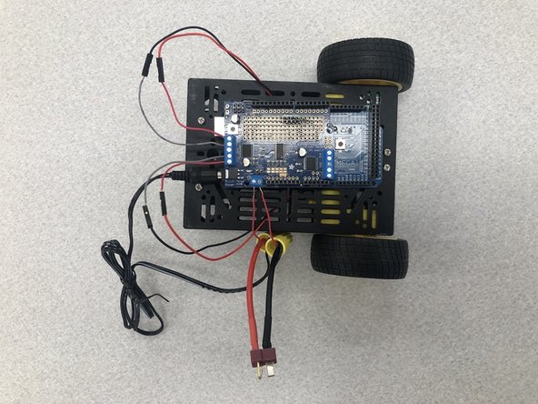 Now we will plug the barrel plug into the Arduino Mega and put the spare wires into the terminal blocks of the motor shield.