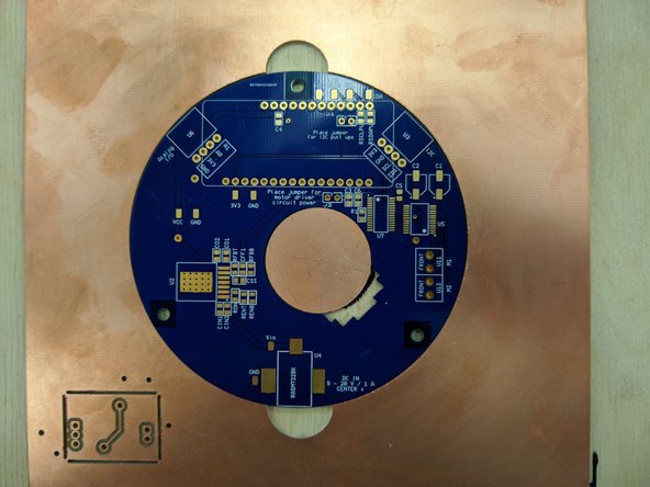 Create a jig or brace to keep your PCB from moving around while you are applying paste.  You can use scrap boards from the PCB mill drawer.   You should tightly pack these scrap boards around your PCB so it cannot move.  Tape the boards in place using blue tape.