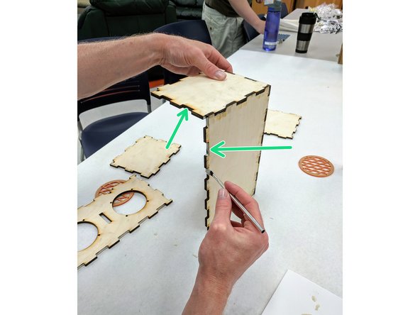 Apply glue to the box assembly along the edges where the front will mate:  the teeth along the front of the bottom piece and the teeth along the front of the side piece.