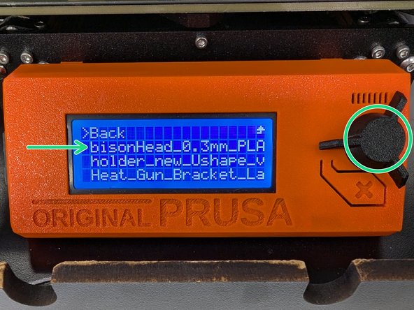 Reinsert the SD card into the printer interface (the SD card label should face away from you).  Your print file should appear at the top of a list of files.  Locate your file by name, rotate the knob to highlight your file, then press the knob to select your file.
