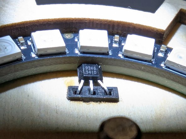 With the sensor securely insert, press on the front face of the sensor and apply pressure to bend the black plastic case backwards.  This will cause the leads to bend.