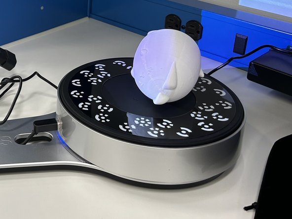 To capture the top/bottom of your object, turn it on it's side and do another scan.