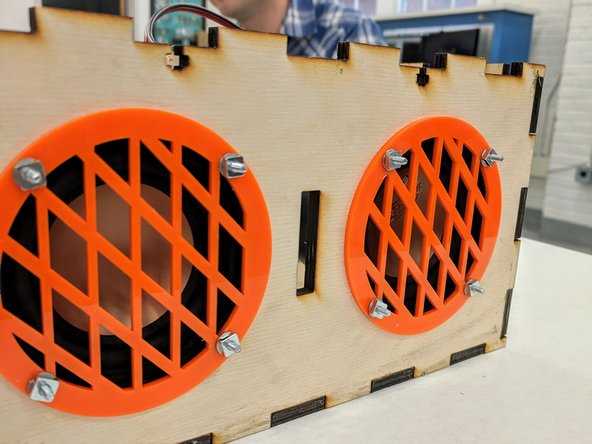 Repeat the last step to fasten the right speaker and grille to the box.  You will use the remaining four screws, washers, and nuts.