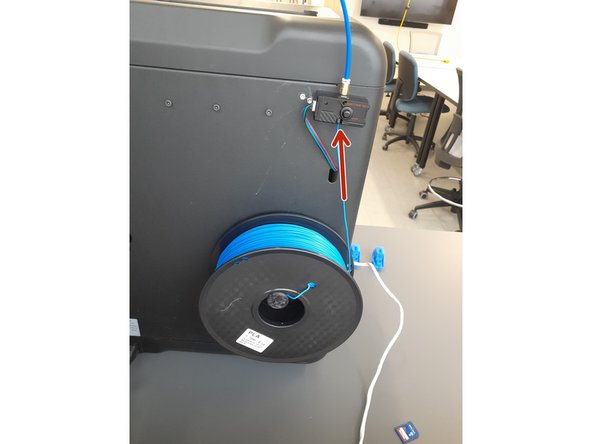 Once it reaches the correct temperature, create a slight inward pressure on the filament until the extruder grabs the end of the filament, pulling it in.