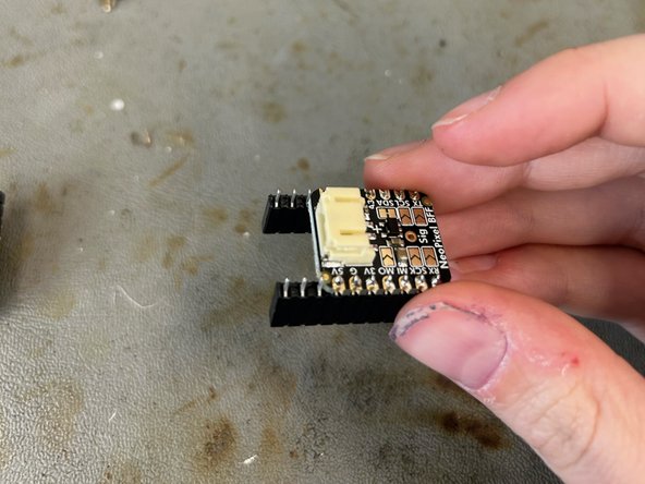 Solder male header pins onto the NeoPixel stick or ring. On the stick, make sure to solder the pins to the side with DIN.