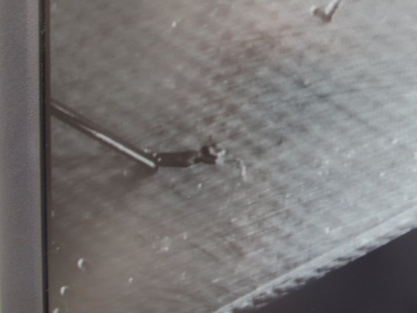 Hold down the foot pedal to engage the pressure to the paste tube.  You should see a small amount of paste dispensed from the nozzle.  To avoid a large blob, slowly move the nozzle from right to left with the placement knob while holding down the foot pedal.