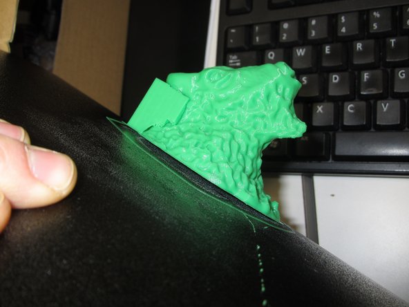 With the metal print surface removed from the printer, carefully bend the surface to free the print from the plate.