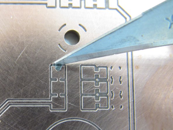 If you feel you have dispensed too much paste, or you have bridged paste between pads or onto the residual copper, it may be necessary to remove paste.  You can use a small bit of paper towel to do this, or a fine knife blade.