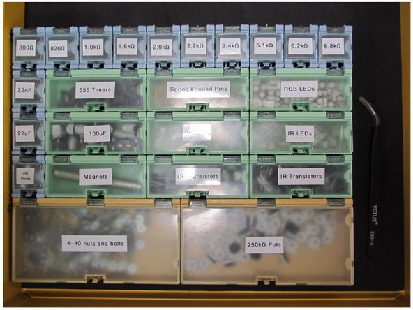 The component bins are all labelled.  It is recommended to take this entire container over with you to the pick and place machine.  There is a set of tweezers in the drawer to aid in picking components out of the bins.  Please be sure to return these tweezers to the drawer, along with the components, when you are finished.